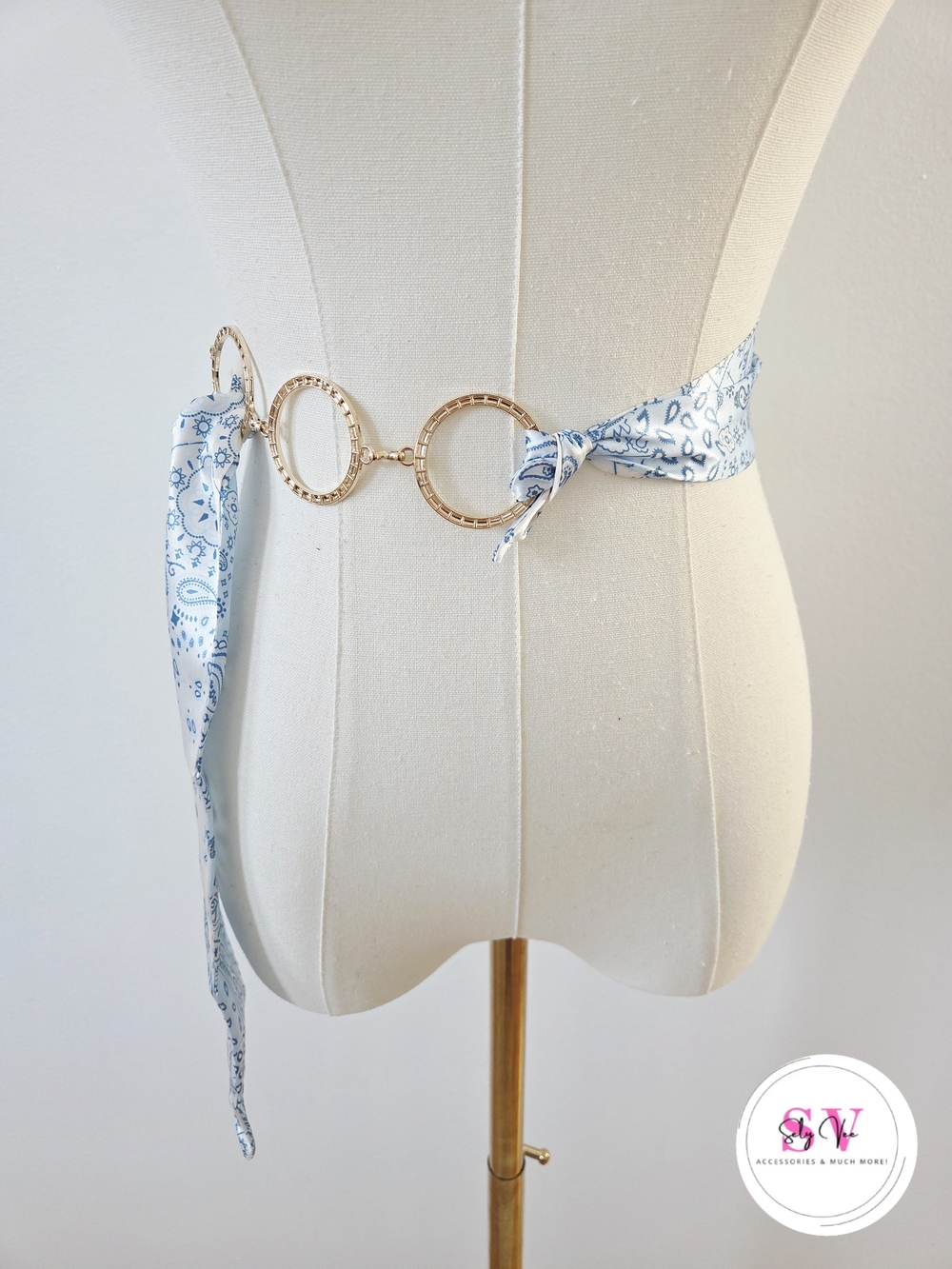 Blue and white paisley print belt with gold accents